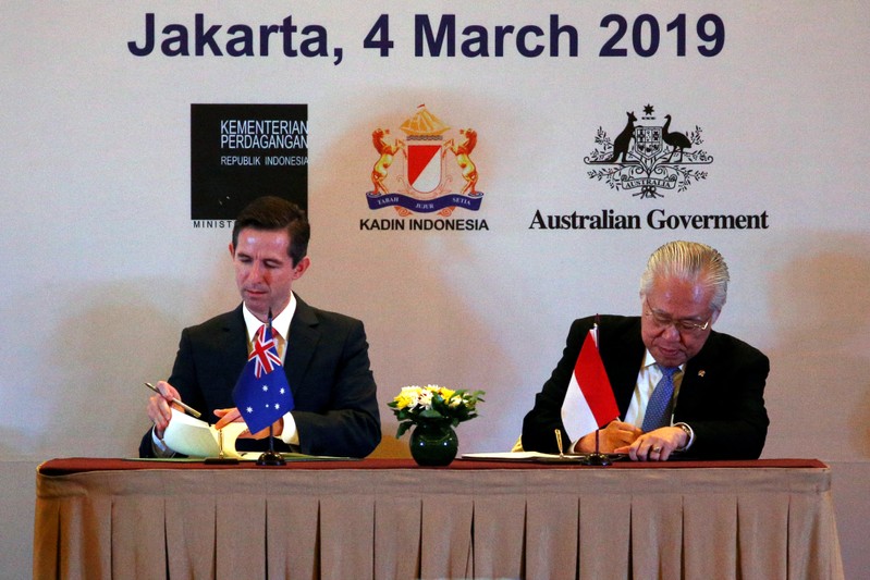 Indonesia's Trade Minister Enggartiasto Lukita and Australia's Minister of Trade, Tourism and Investment Simon Birmingham sign an economic partnership agreement aimed at boosting trade and investment during a ceremony in Jakarta