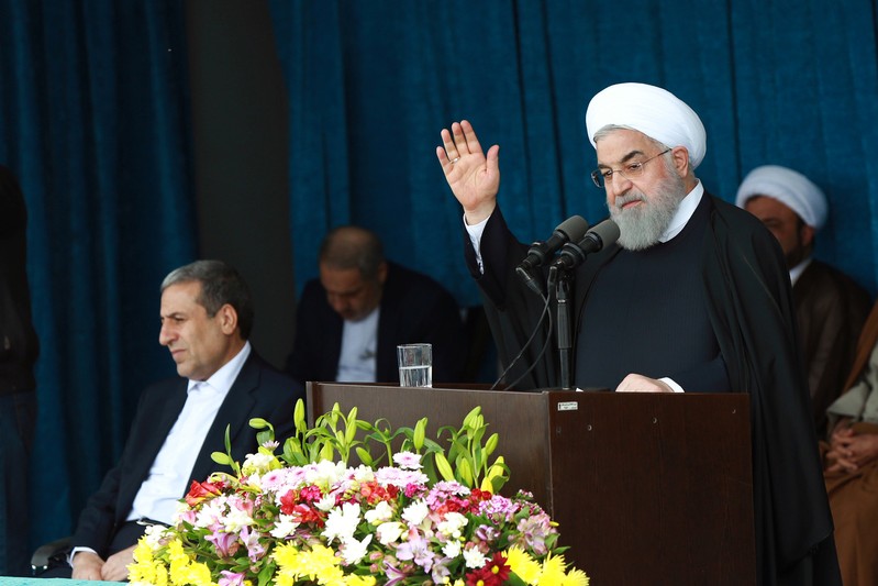 Iranian President Rouhani gestures to the crowd at a public speech in Bandar Kangan