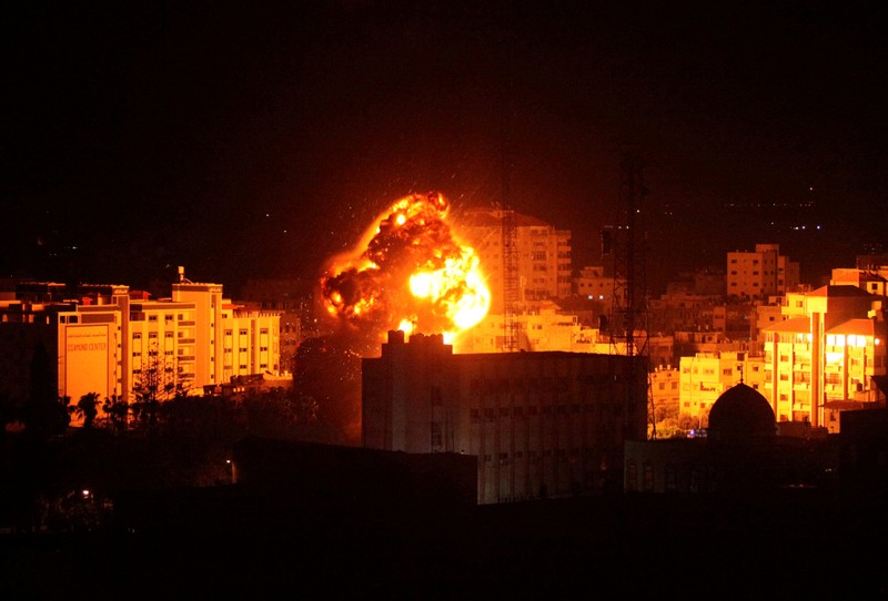 Flame and smoke are seen during an Israeli air strike in Gaza City