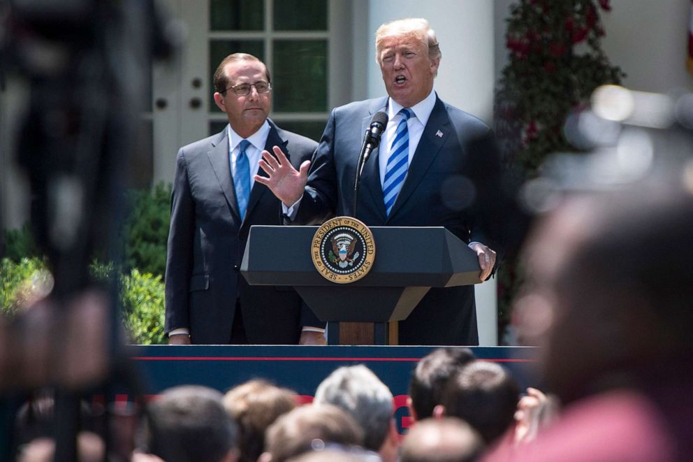 President Donald J. Trump speaks, with Health and Human Services Secretary Alex Azar by his side, during an event on lowering drug prices in the Rose Garden of the White House, May 11, 2018.