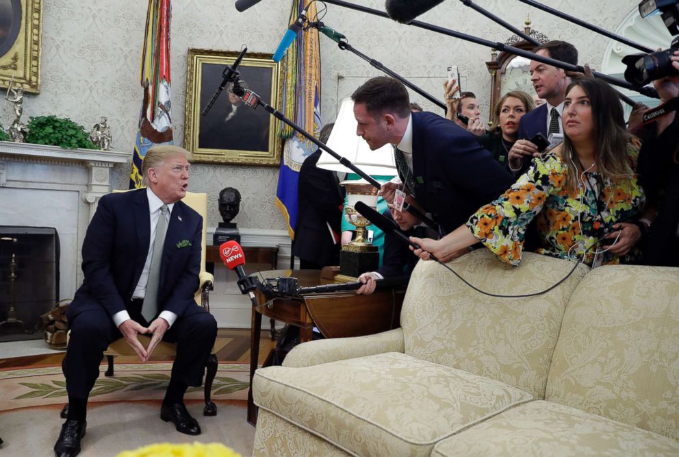 President Donald Trump talks to the press during a meeting in the Oval Office of the White House, March 14, 2019.