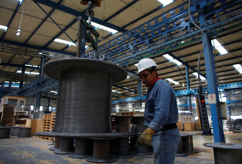 FILE PHOTO - Worker holds stainless steel wire produced at TIM stainless steel wire factory in Huamantla