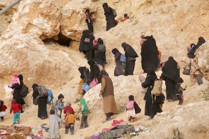 FILE PHOTO: Surrendering families of Islamic State militants in the village of Baghouz, Deir Al Zor province, Syria
