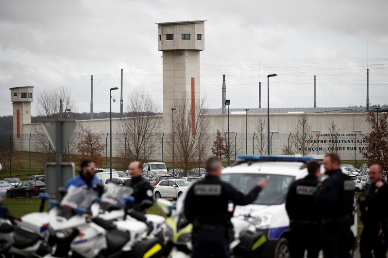 French police take postion outside the prison where an inmate in one of France's most secure prisons stabbed two guards with a knife in Conde-sur-Sarthe