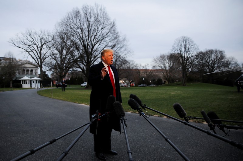 U.S. President Donald Trump speaks to reporters as he returns to the White House in Washington