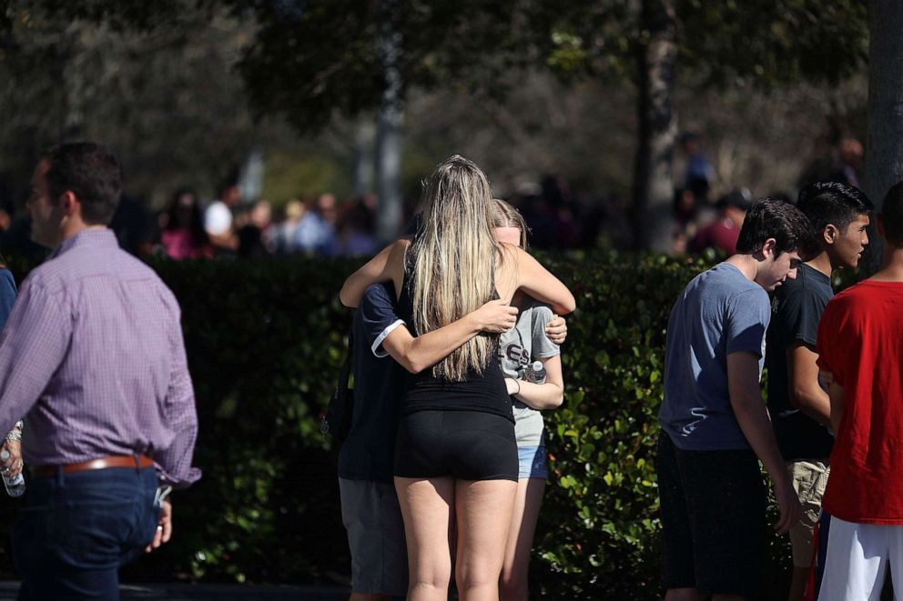 Students of Marjory Stoneman Douglas High School gather at Pine Trail Park, on Feb. 15, 2018 in Parkland, Fla., the day after a mass shooting in the school.