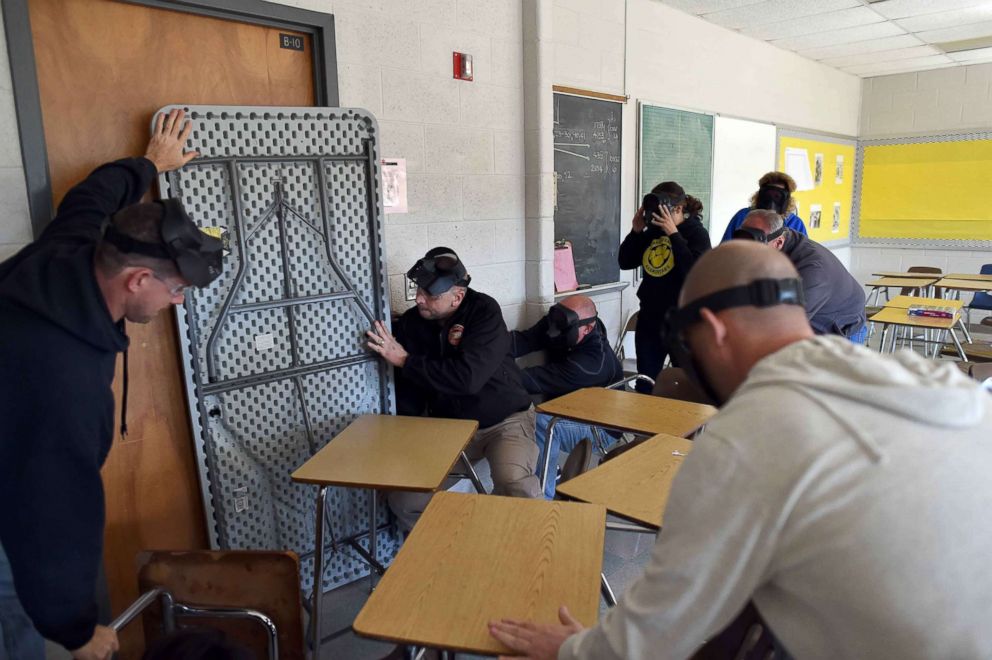 Participants barricade a door of a classroom to block an "active shooter" during ALICE (Alert, Lockdown, Inform, Counter and Evacuate) training at the Harry S. Truman High School in Levittown, Penn., Nov. 3, 2015.