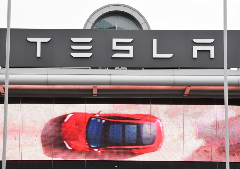An advertising screen is seen outside a Tesla showroom in west London, Britain