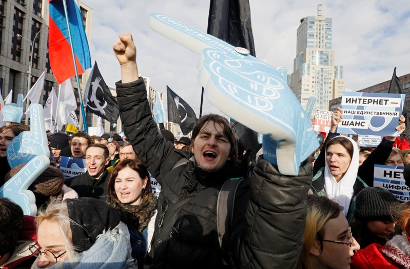 People shout slogans during a rally to protest against tightening state control over internet in Moscow