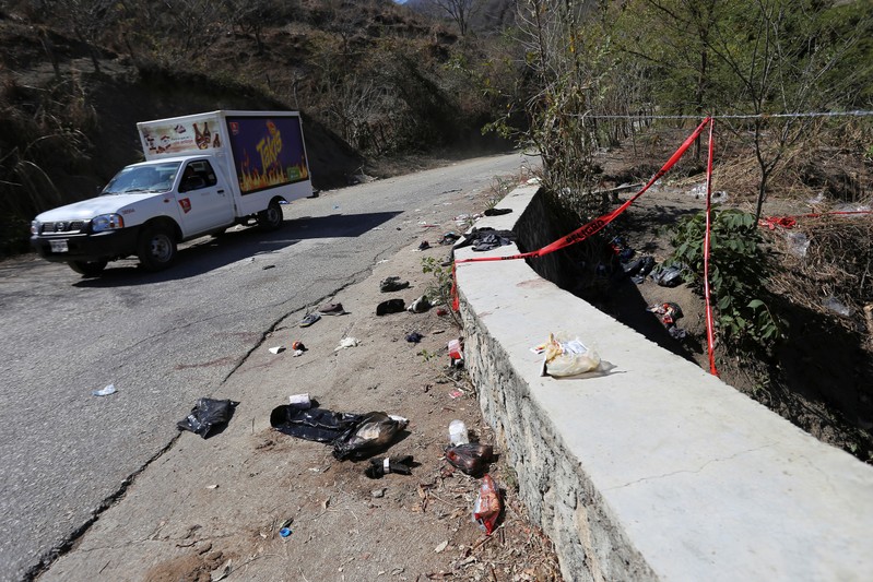 A view shows clothing and items scattered on the site where a cargo truck careened off a road and turned over, killing at least 25 migrants from Central America, in Francisco Sarabia