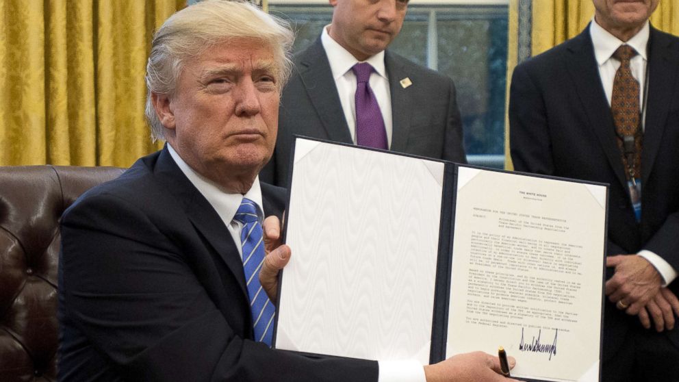 President Donald Trump holds an executive order titled "Mexico City Policy", which bans federal funds going to overseas organizations that perform abortions, Jan. 23, 2017.