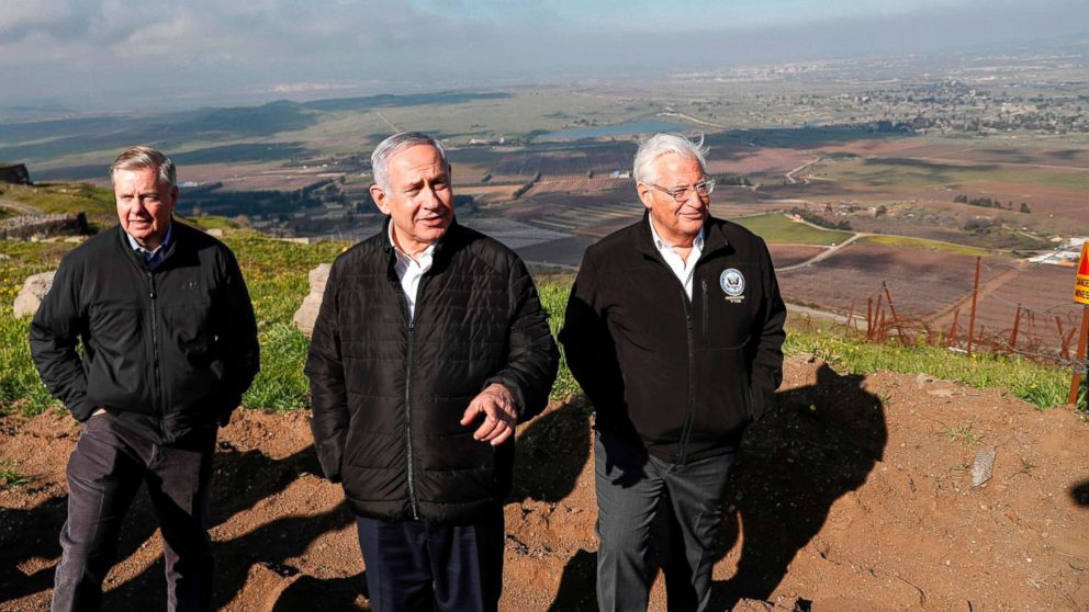 Sen. Lindsey Graham is accompanied by Israeli Prime minister Benjamin Netanyahu and U.S. Ambassador to Israel David Friedman as they visit the border line between Syria and the Israeli-annexed Golan Heights on March 11, 2019.