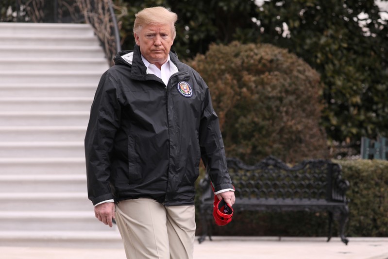 U.S. President Trump walks out to talk to reporters as he departs for travel to Alabama and Florida from the White House in Washington