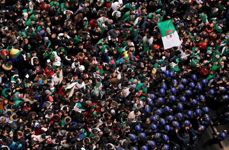 FILE PHOTO: Police officers attempt to disperse demonstrators trying to force their way to the presidential palace during a protest calling on President Abdelaziz Bouteflika to quit, in Algiers