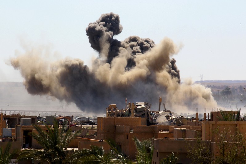 FILE PHOTO: Smoke rises from the last besieged neighborhood in the village of Baghouz, Deir Al Zor province