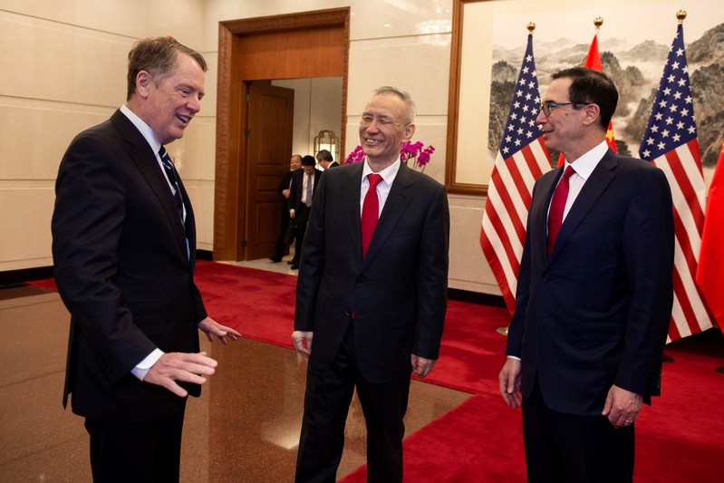 China's Vice Premier Liu He (C) talks with US Treasury Secretary Steven Mnuchin (R) and US Trade Representative Robert Lighthizer (L) at Diaoyutai State Guesthouse in Beijing