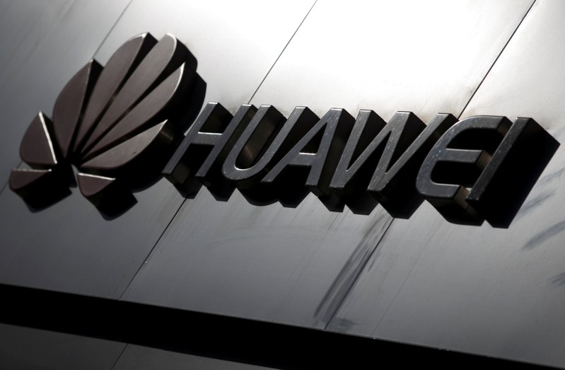FILE PHOTO: The Huawei brand logo is seen above a store of the telecoms equipment maker in Beijing