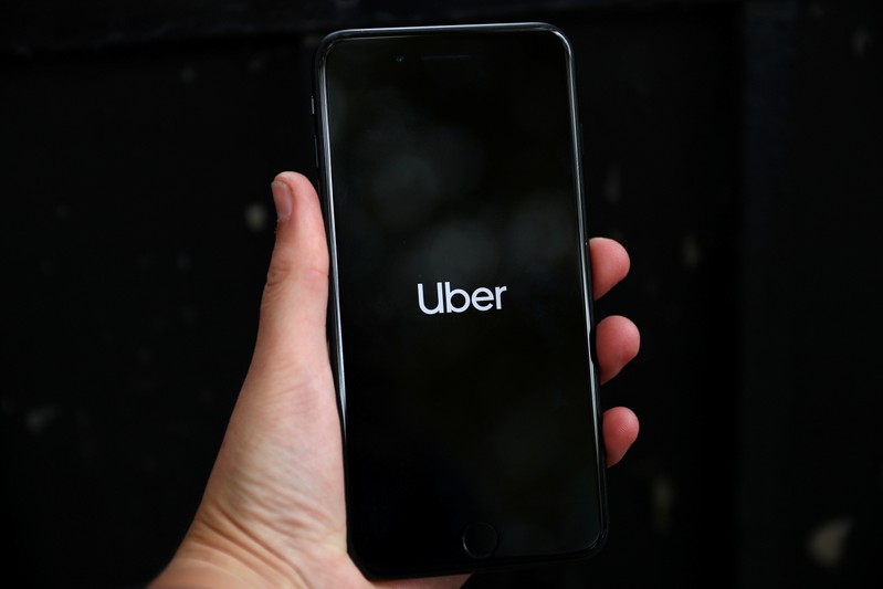 FILE PHOTO: Uber's logo is displayed on a mobile phone