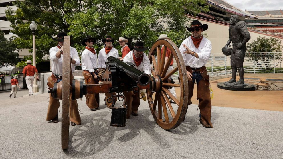 Members of the Texas Cowboys push Smokey the Cannon to the stadium before the game between the Texas Longhorns and the TCU Horned Frogs at Darrell K Royal-Texas Memorial Stadium in this Sept. 22, 2018 file photo in Austin, Texas.