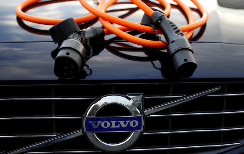 FILE PHOTO: An electric vehicle charging cable is seen on the bonnet of a Volvo hybrid car in this picture illustration