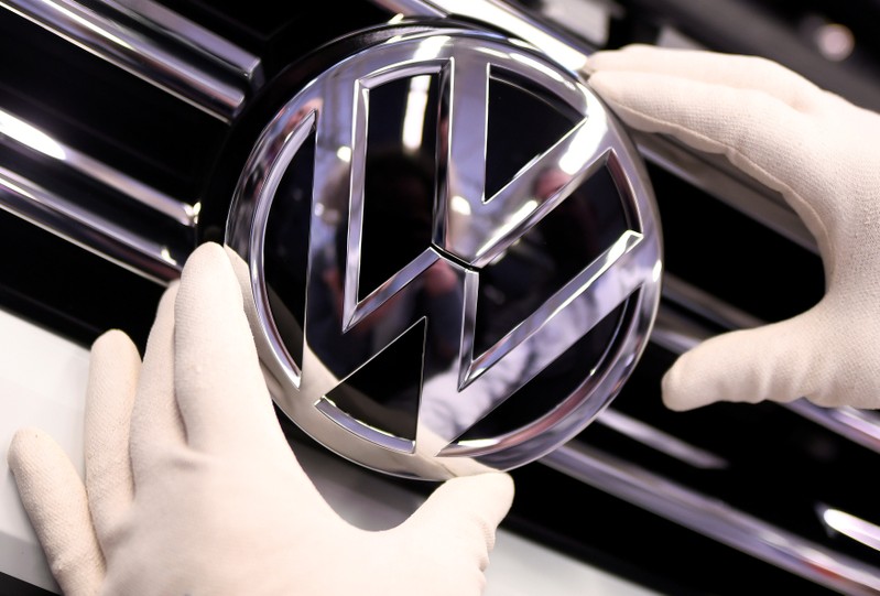 FILE PHOTO: A Volkswagen badge on a production line at the VW plant in Wolfsburg, Germany