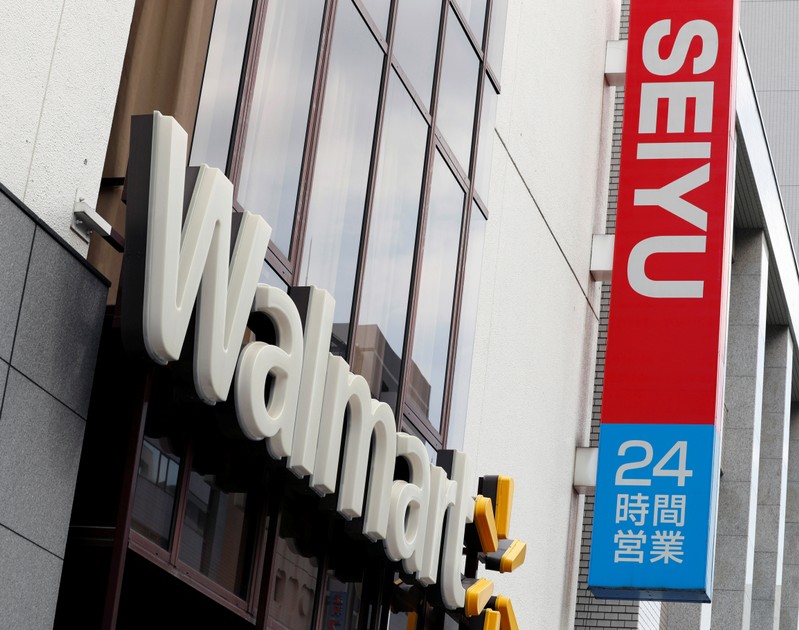 FILE PHOTO: Logos of Walmart and Seiyu are pictured at the headquarters office in Tokyo