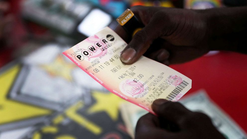 George Hollins buys a Powerball ticket at the Shell Gateway store, March 26, 2019, in Boynton Beach, Florida.