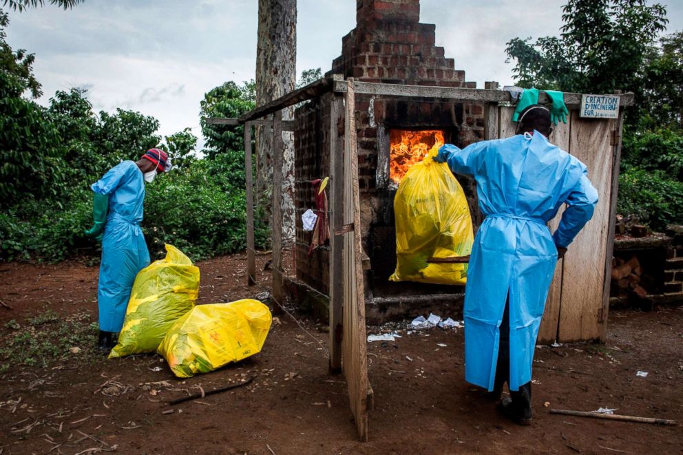Health workers burn medical waste generated during care of patients with the Ebola virus, Aug. 21, 2018, in Mangina, Democratic Republic of the Congo.