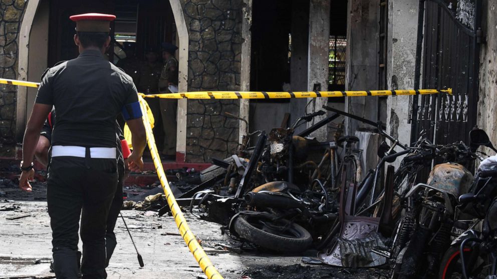 Sri Lankan security personnel walk past debris outside Zion Church following an explosion in Batticaloa, Sri Lanka, April 21, 2019.