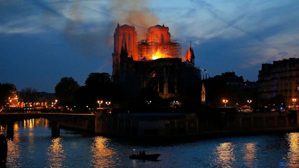 Firefighters tackle the blaze as flames rise from Notre Dame cathedral as it burns in Paris, April 15, 2019.