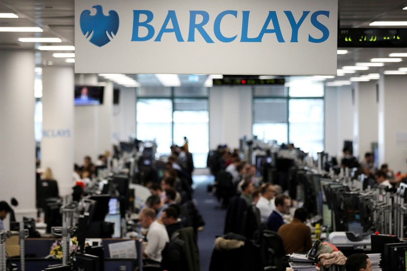 FILE PHOTO: Traders work on the trading floor of Barclays Bank at Canary Wharf in London