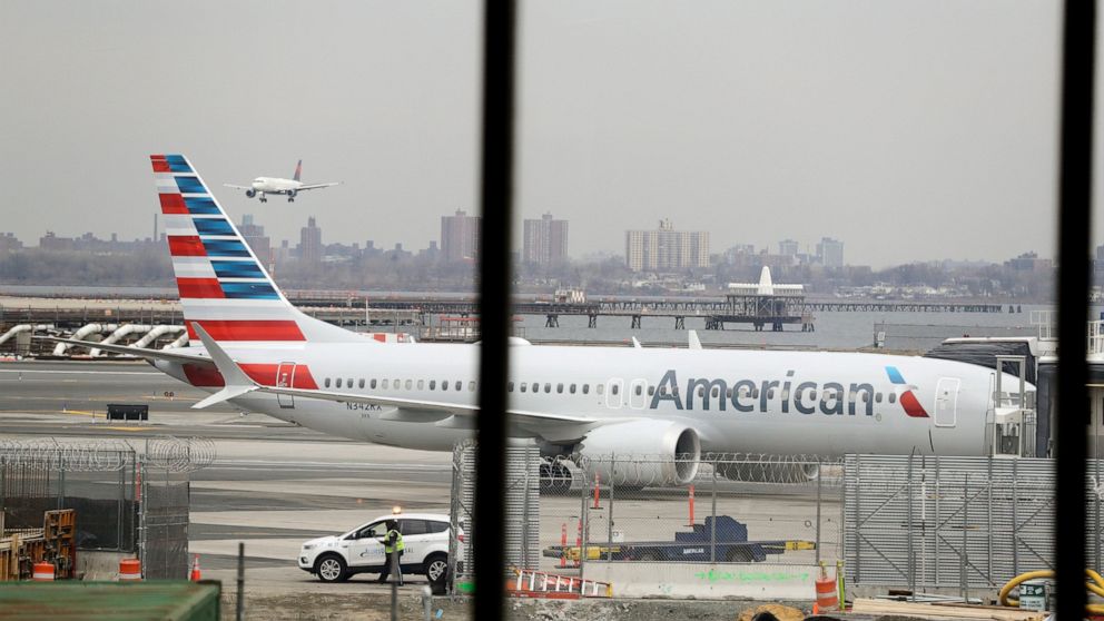 In a March 13, 2019 file photo, an American Airlines Boeing 737 MAX 8 sits at a boarding gate at LaGuardia Airport in New York.