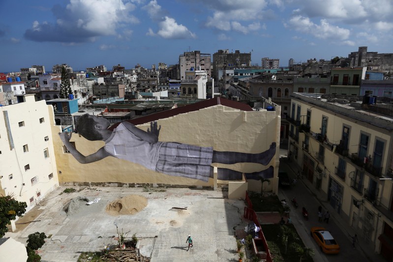 A giant photograph of a boy by French photographer and artist JR is seen on a wall, during the 13th Havana Biennial, in Havana