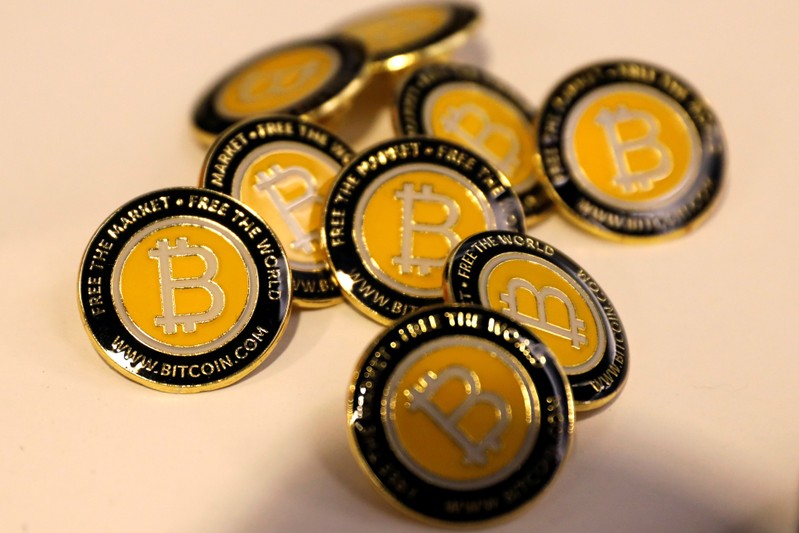 FILE PHOTO: Bitcoin.com buttons are seen displayed on the floor of the Consensus 2018 blockchain technology conference in New York City
