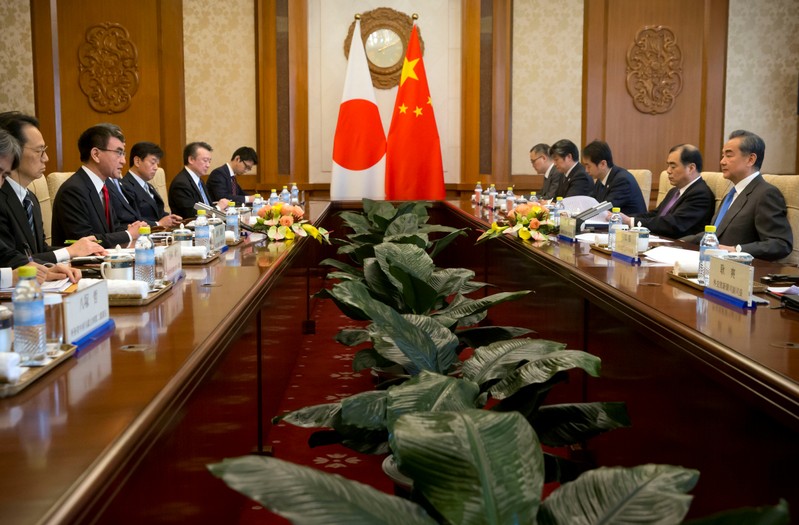 Japanese Foreign Minister Taro Kono talks during a meeting with Chinese Foreign Minister Wang Yi at the Diaoyutai State Guesthouse in Beijing