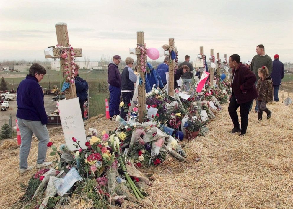 Mourners visit a memorial of crosses on a hill overlooking Columbine High School in Littleton, Colo., on May 1, 1999.