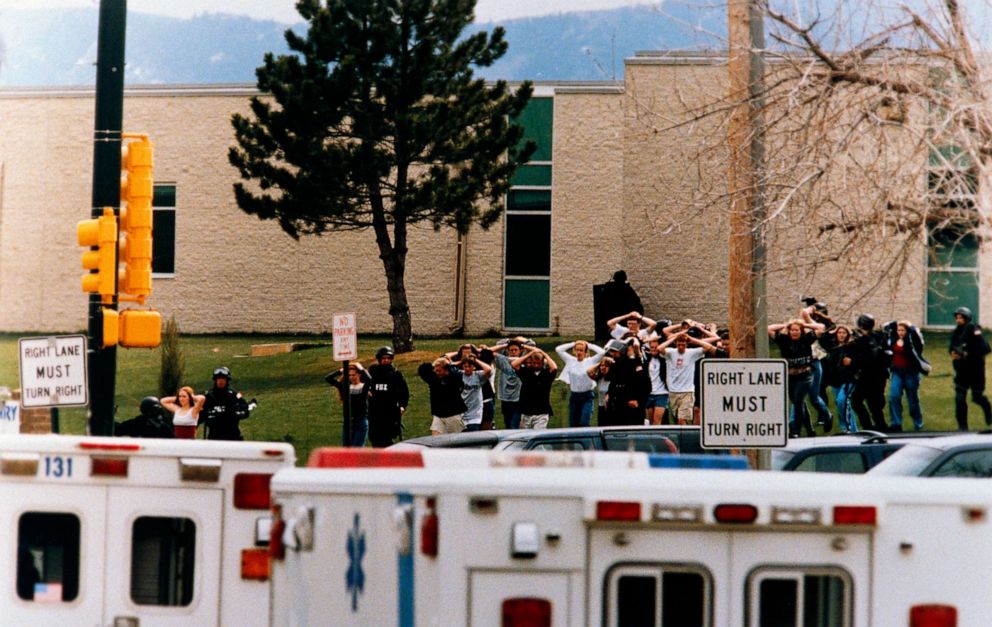 Students run out of the Columbine High School as two gunmen went on a shooting spree in Columbine High School in Littleton, Colo., April 20, 1999.