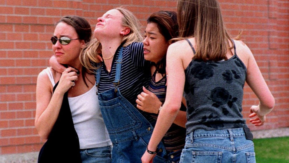 Young women head to a location near Columbine High School where students and faculty members were evacuated after two gunmen went on a shooting rampage in the school in the southwest Denver suburb of Littleton, Colo., April 20, 1999.