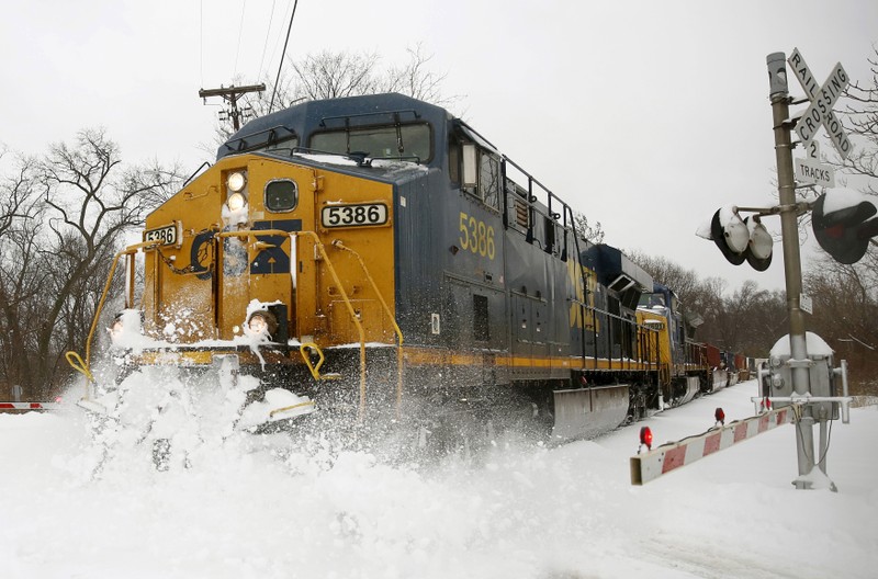 File photo of a CSX freight train blasting through high snow at a crossing in Silver Spring