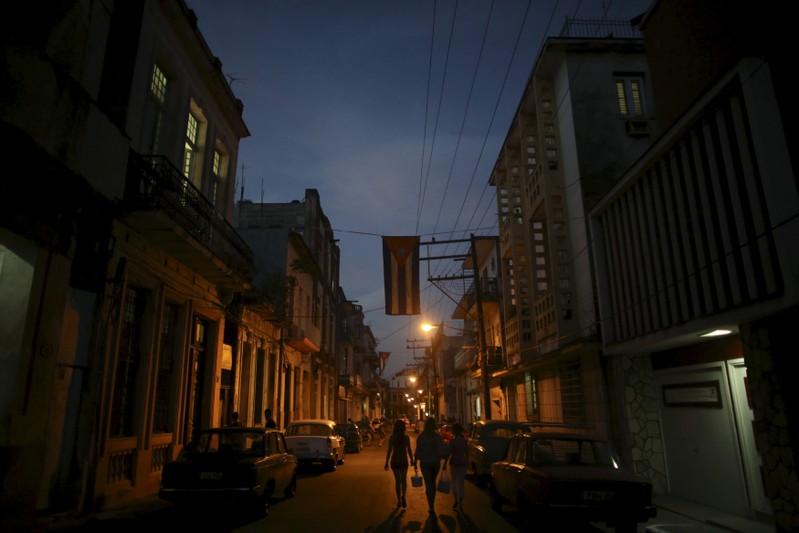 People walk on a street in downtown Havana