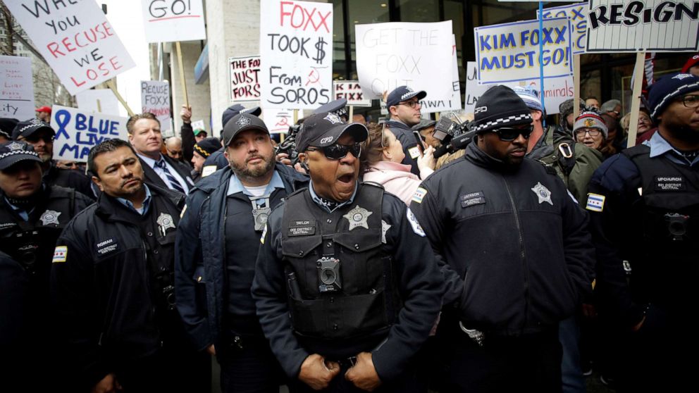 Chicago police officers stand in front of Fraternal Order of Police supporters protesting the handling of the Jussie Smollett case by the State's Attorney Kim Foxx in Chicago, April 1, 2019.