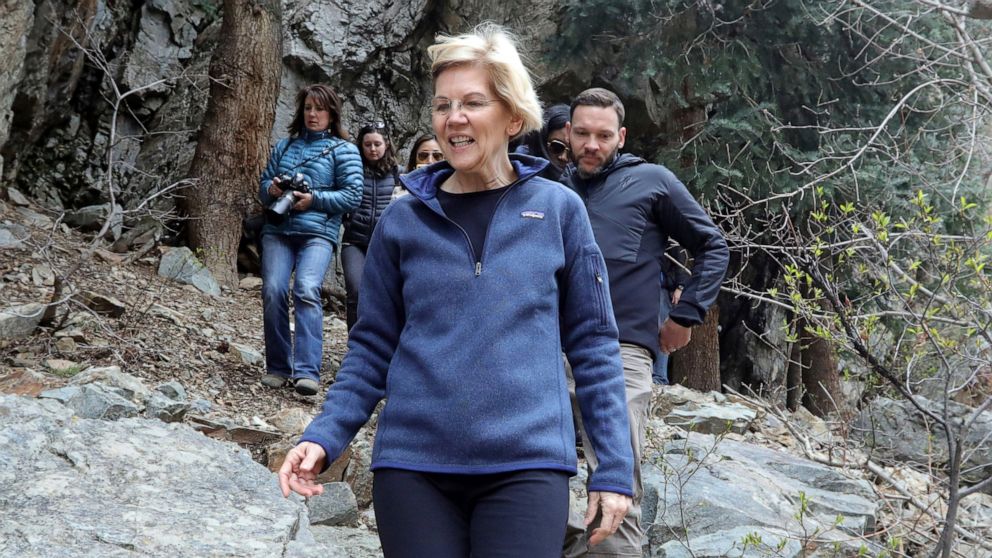 Democratic presidential candidate Sen. Elizabeth Warren, D-Mass., walks with Carl Fisher, of Save Our Canyons, during an visit to Big Cottonwood Canyon Wednesday, April 17, 2019, east of Salt Lake City.