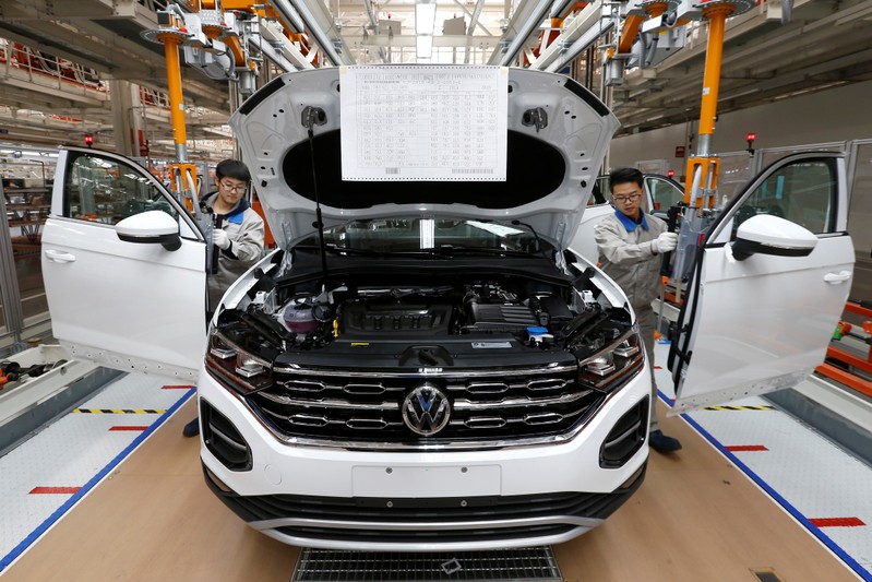 Workers are seen at the production line for Volkswagen Tayron cars at the FAW-Volkswagen Tianjin Plant