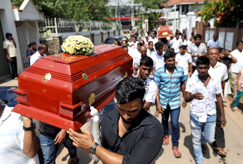 Friends and relatives carry the coffins of eight-month-old Mathew and his grandmother Agnes Vnikpridha, 69, who died during a string of suicide bomb attacks on churches and luxury hotels on Easter Sunday, at their funeral in Negombo