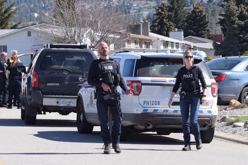 Royal Canadian Mounted Police (RCMP) officers attend a crime scene on Cornwall Drive, after a series of attacks in which four people were shot dead, in Penticton