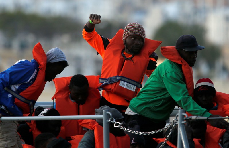 Migrants who were stranded on the German NGO Sea-Eye migrant rescue ship Alan Kurdi are seen before disembarking from an Armed Forces of Malta patrol boat at its base in Marsamxett Harbour, Valletta