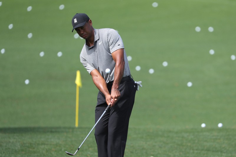 Tiger Woods of the U.S. chips onto the practice green during the second day of practice for the 2019 Masters golf tournament at the Augusta National Golf Club in Augusta, Georgia, U.S.