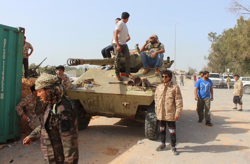Members of the Libyan internationally recognised government forces gather around APC at Khallat Farjan area in Tripoli
