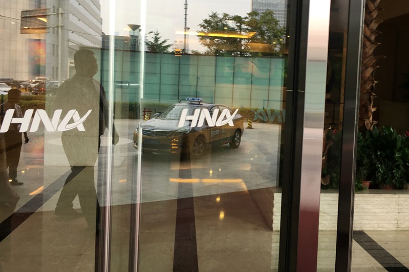 FILE PHOTO: The HNA Group logo is seen on the gate of HNA Plaza building in Beijing