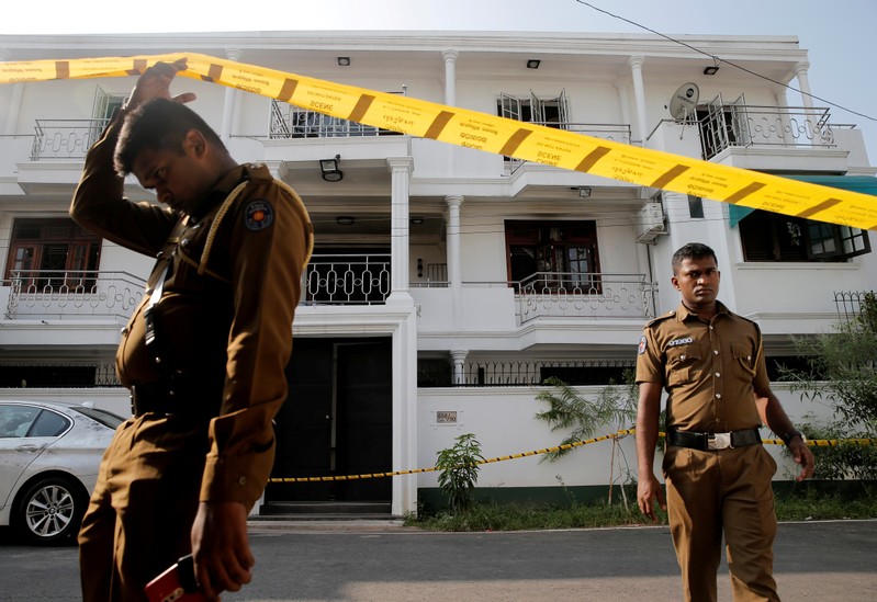 FILE PHOTO: Police keep watch outside the family home of a bomber suspect where an explosion occurred during a Special Task Force raid in Colombo